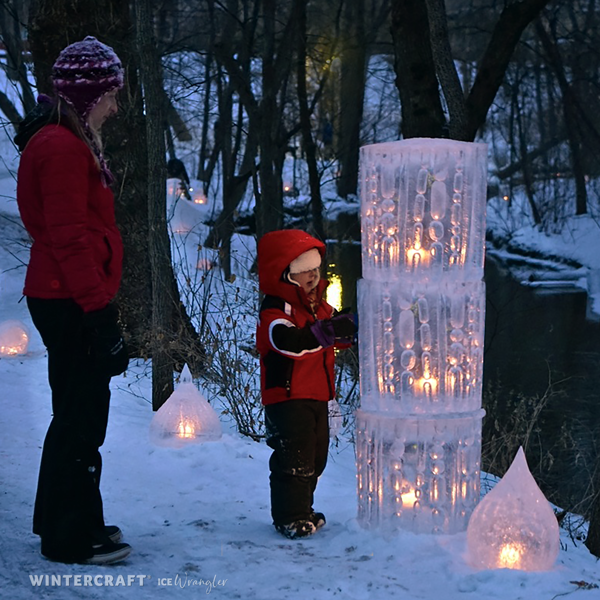 child looking at Finnish Glass Ice Lantern Tower Wintercraft Ice Luminary Magic