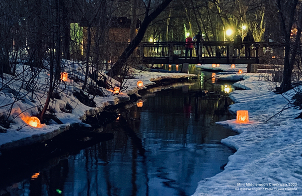 creekwalkers on the bridge looking at ice lanterns wintercraft ice wrangler photo by Jana Freiband