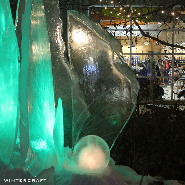 Wintercraft Frozen Luminary Ice Art Installation at REI flagship store Store window in background lit with LED lights and candles