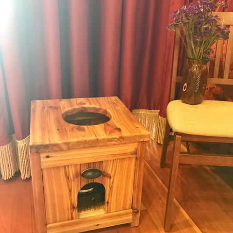 a box made of cedar has a whole cut in the top for sitting and receiving a steam treatment in the pelvic area