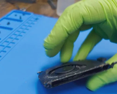 A close-up of a technician's hands from Prime Tech Support in Miami,
    Florida, as they handle a fan component.