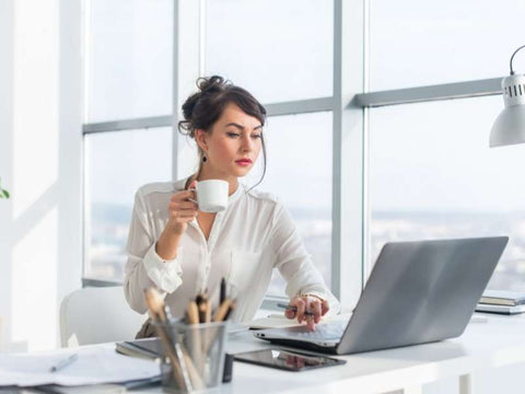 Woman using her laptop in Miami while our team offers IT assistant to solve her Laptop Slow Performance 