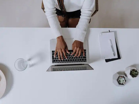 Person using her laptop in Miami and reading about laptop liquid damage repairs in Prime Tech Support blog