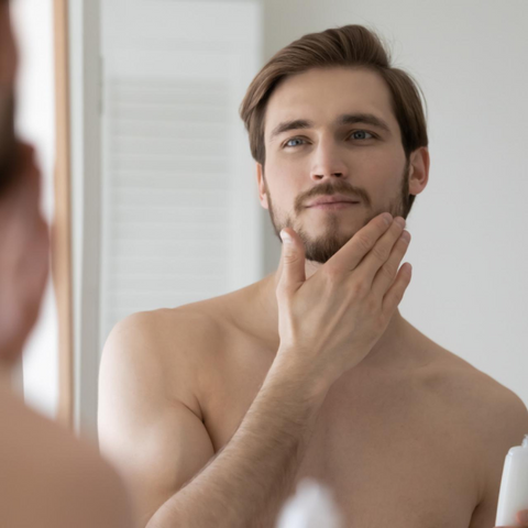 man checking facial hair