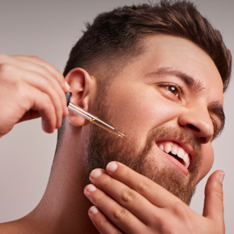 man using beard oil