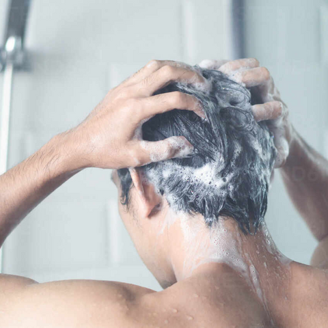 man in the shower washing hair