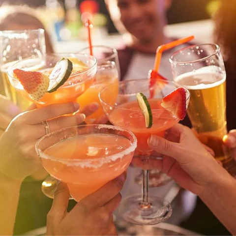 friends clinking cocktails glasses together