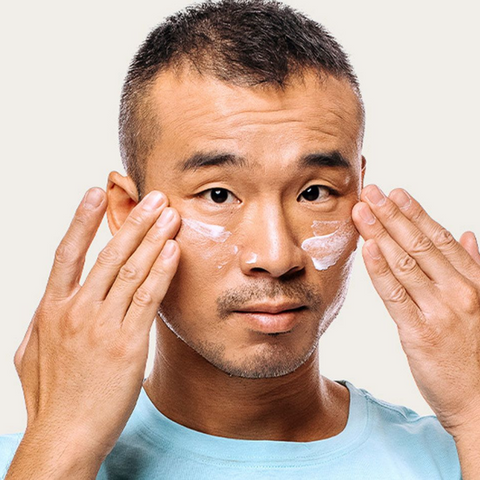 man using skin cream