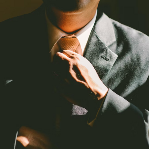 man fixxing necktie