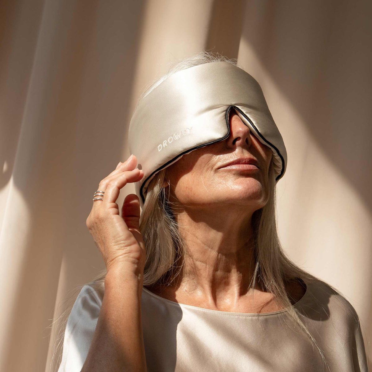 Model with blue Drowsy sleep mask covering eyes 