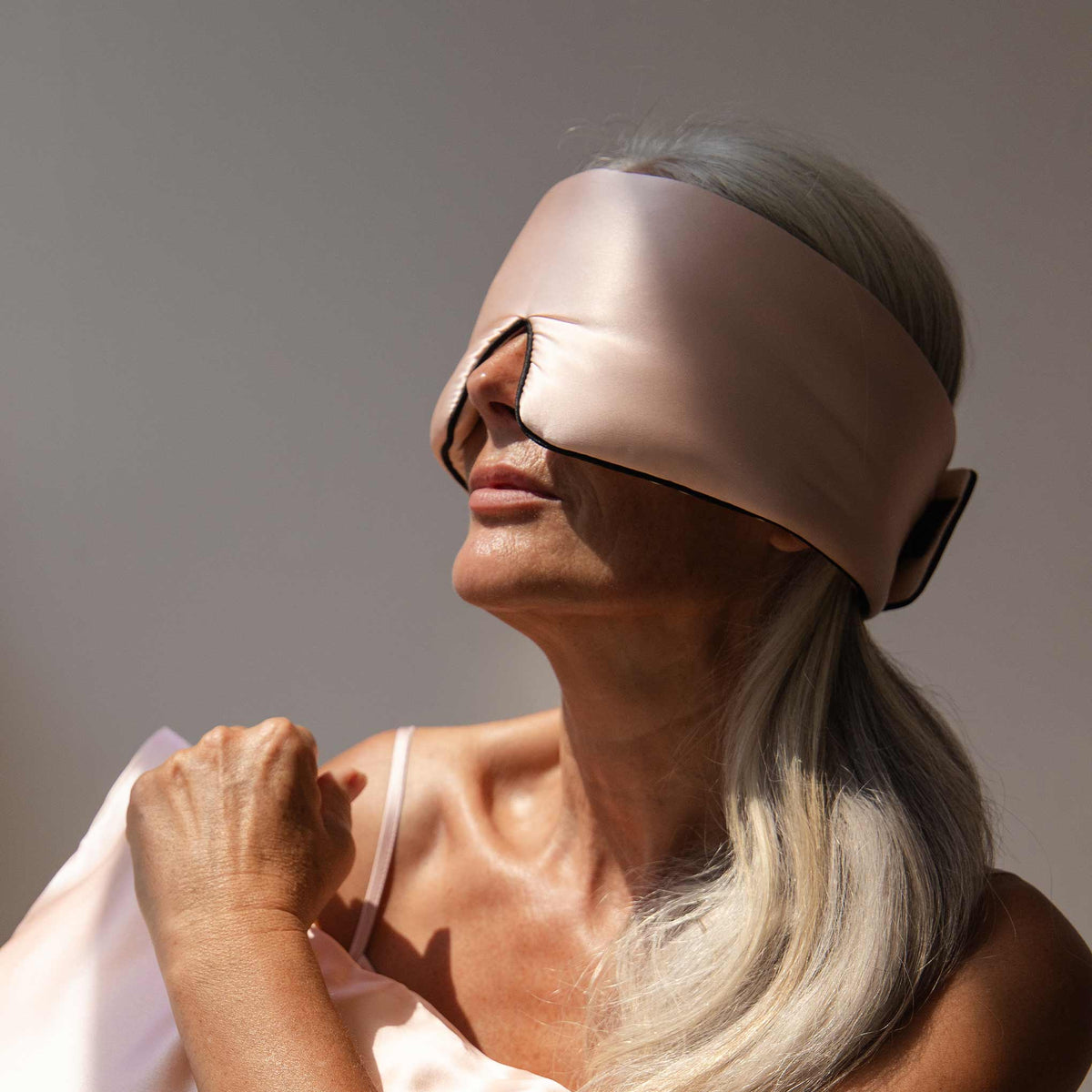 Model with blue Drowsy sleep mask covering eyes 