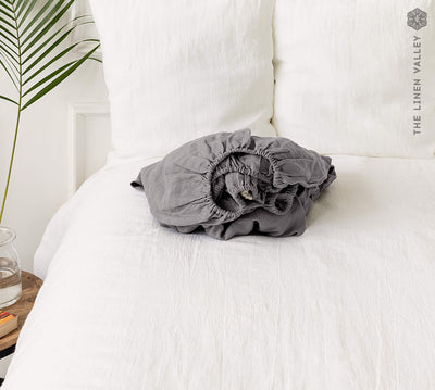 Our charcoal gray linen fitted sheet, the epitome of modern bedroom luxury.