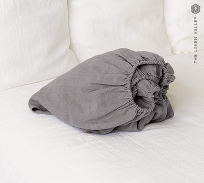 Our charcoal gray linen fitted sheet, the epitome of modern bedroom luxury.