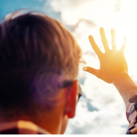 Man holding his hand up against the sun