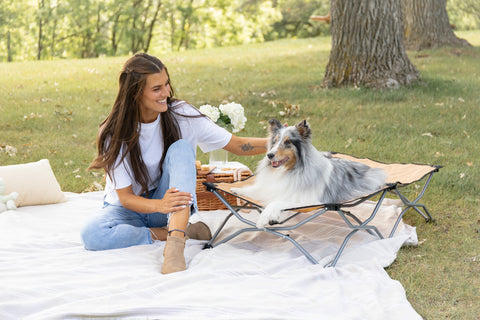 woman next to dog at park