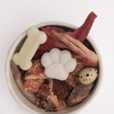 raw pet food bowl with chicken feet