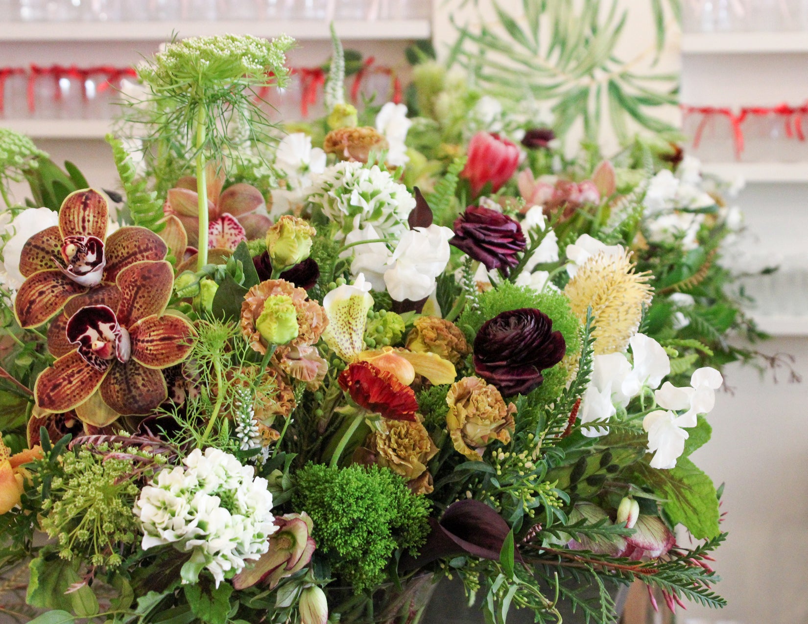 wildflora forest floor event flowers lush woodland orchid pincushion protea ranunculus green verde yellow red purple violet mauve white queen anne's lace pitcher plant sweet pea peacock foliage leaf fern fairytale faerie wedding