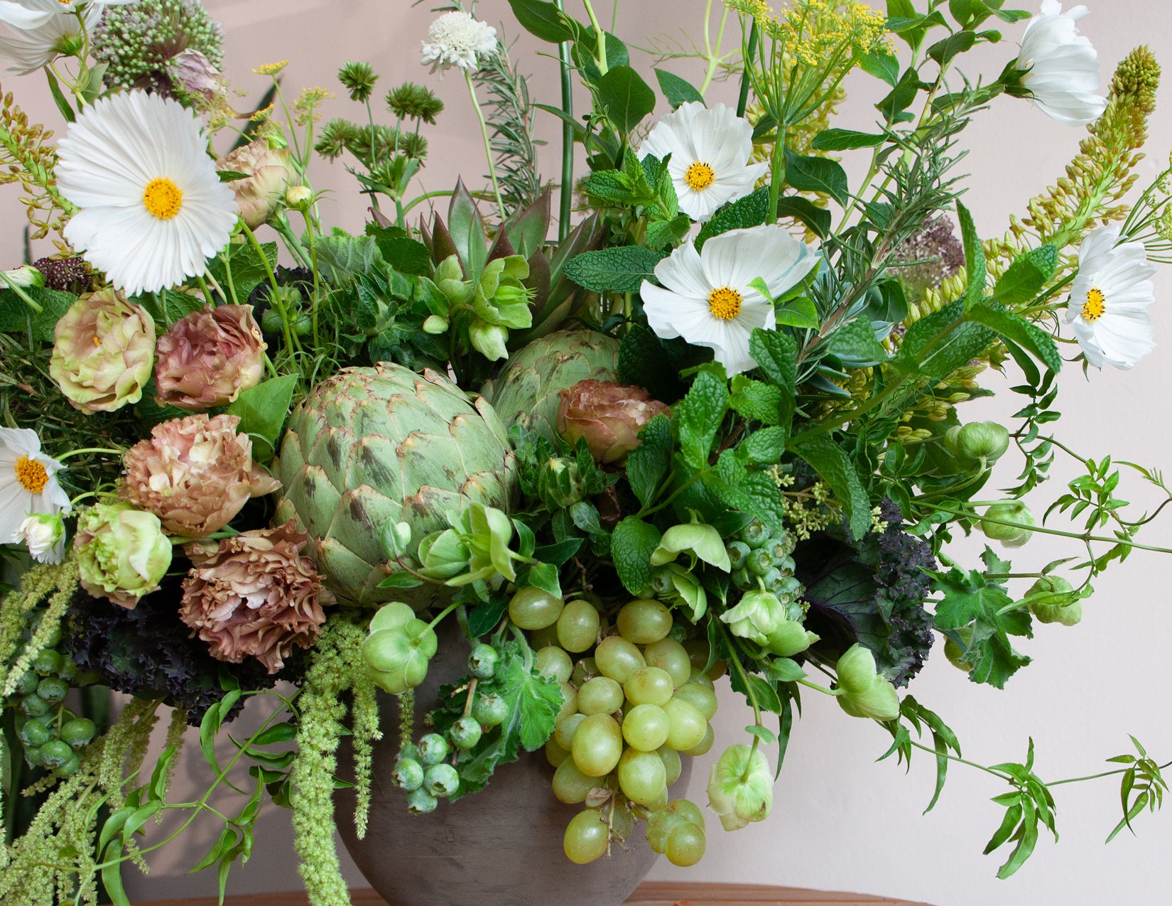 Lush, green, Mediterranean-inspired Flower arrangements created by WildFlora in Los Angeles using Cosmos, Lisianthus, Foxtail Lily, Amaranthus, Allium, Queen Anne's Lace, Delphinium, and Centaurea, grapes, artichoke, mint, rosemary, kale, cabbage, & berries.