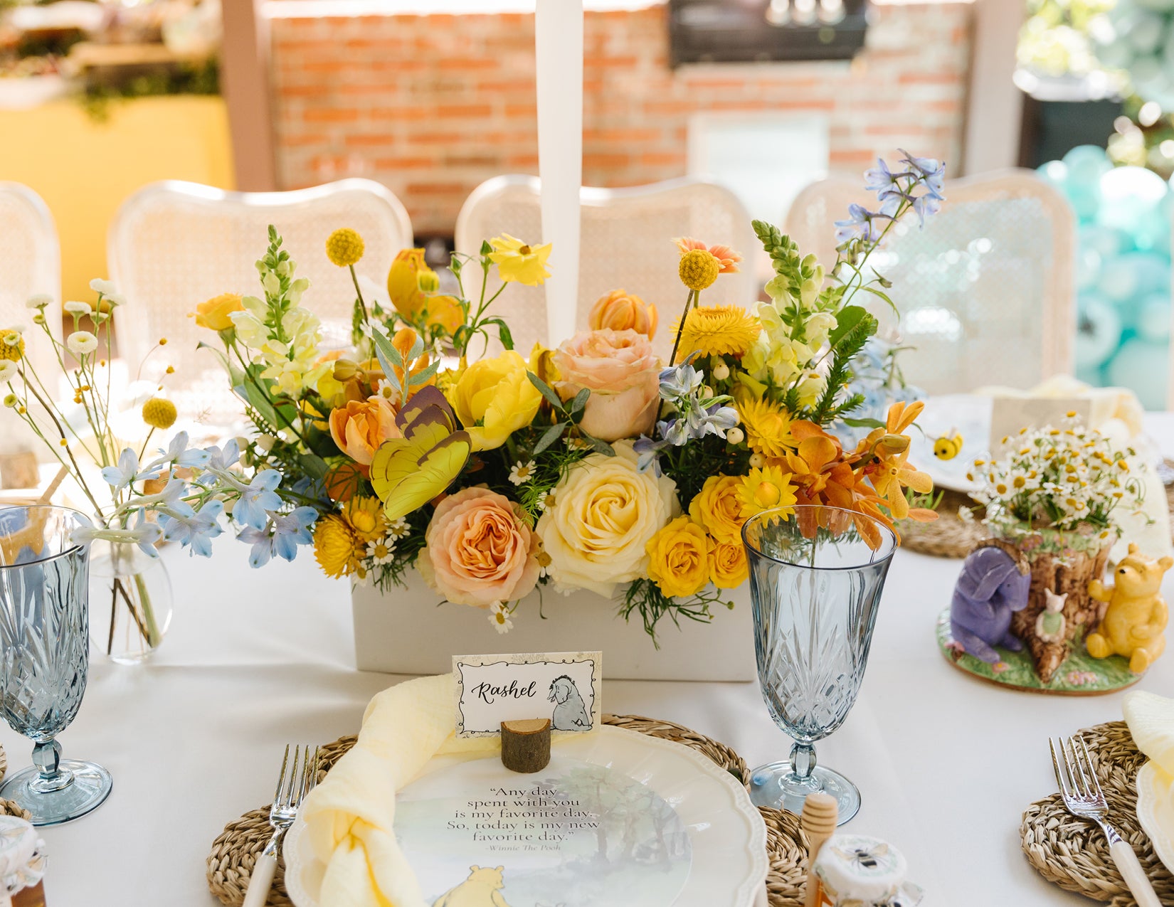 WildFlora baby shower winnie the pooh themed yellow blue peach white orange summer flowers floral arrangement outdoor event tablescape