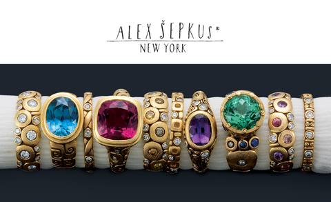 row of gold rings with colorful gemstones by alex sepkus