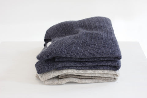 stack of paychi guh cashmere sweaters