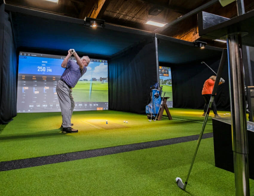 Man golfing in a commercial golf sim