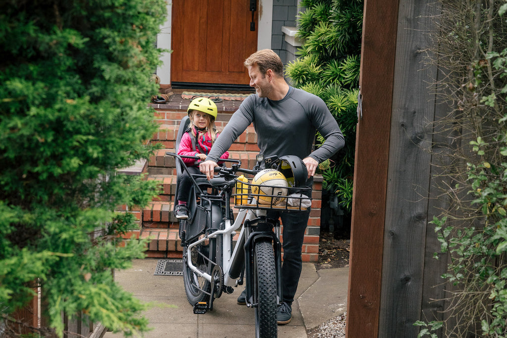 man with daughter on ultra bike