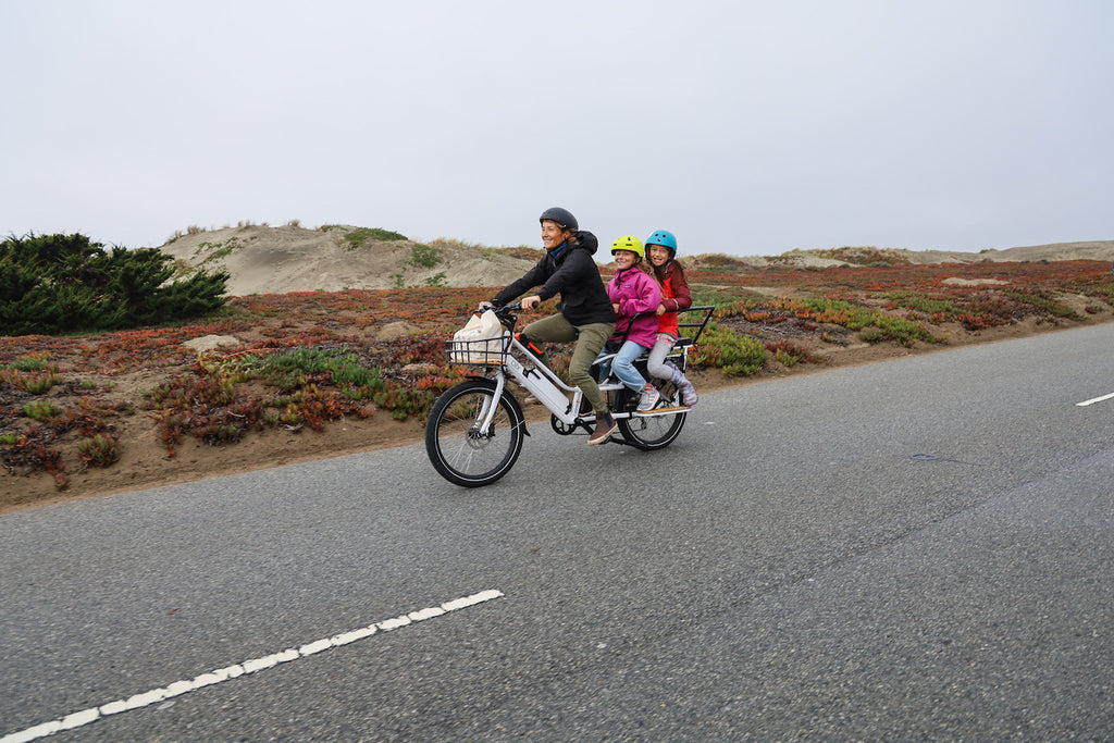 women on bike with kids
