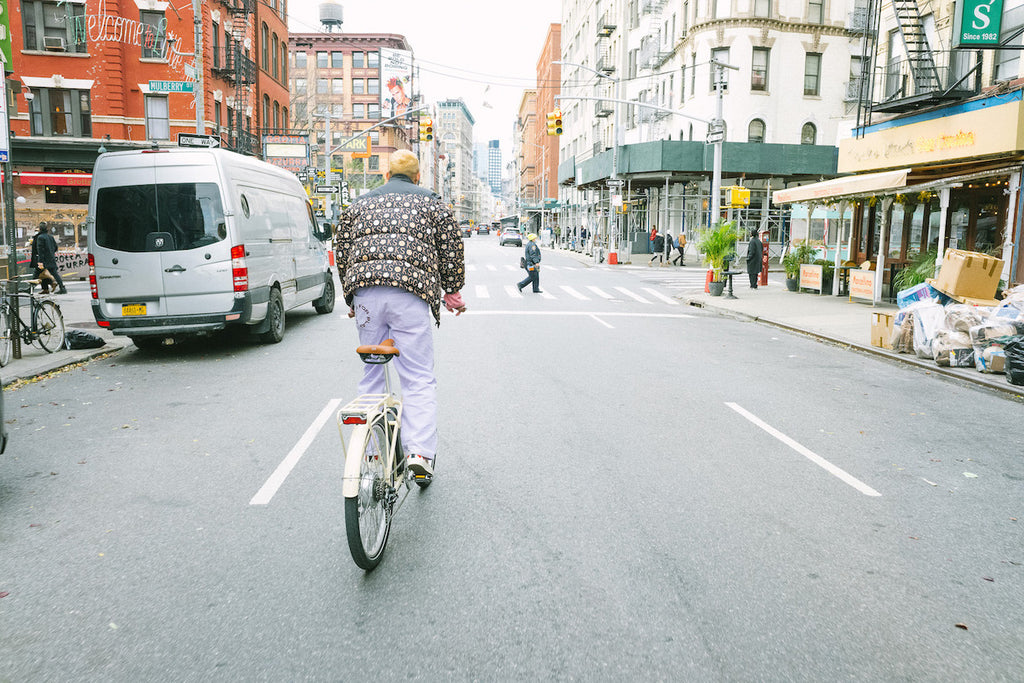 man riding bike with jacket