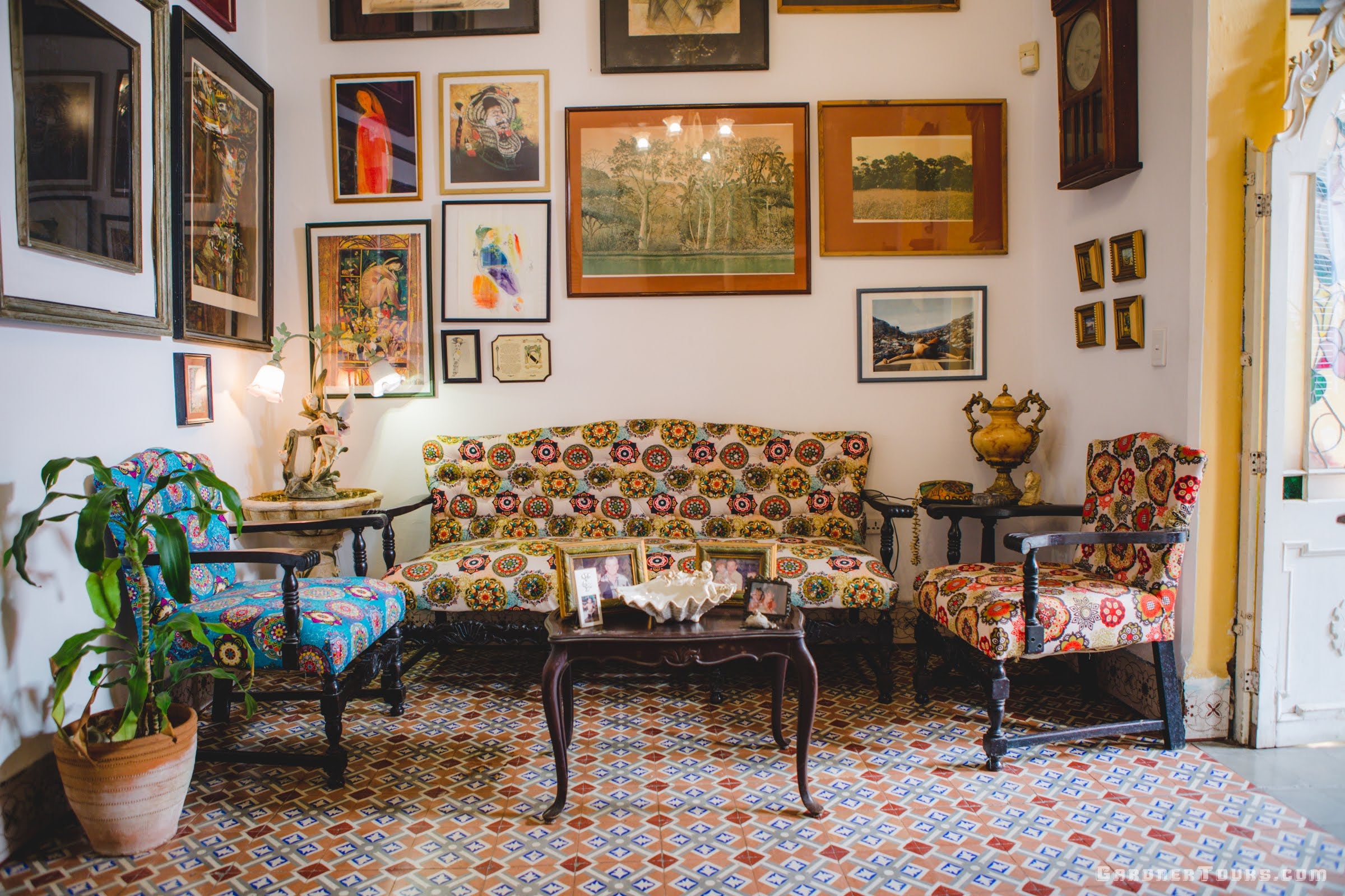 Gardner Tours Beautiful Colorful Living Room with Paintings and Tiled Floors at a Private BnB in Havana, Cuba