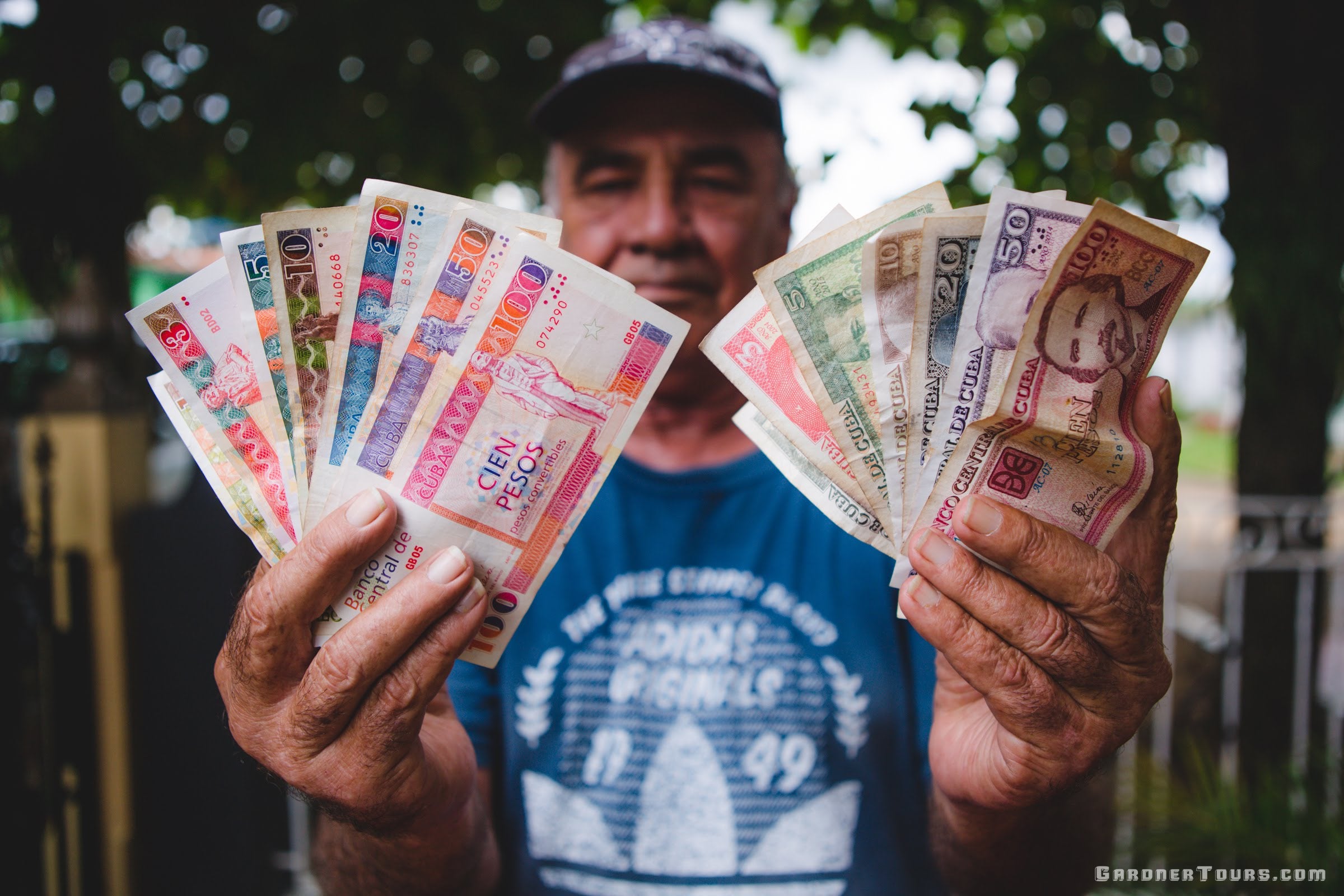 Gardner Tours Custom Cuba Tours Cuban Roberto Old Man Showing You The Difference in Cuban Money Currencies