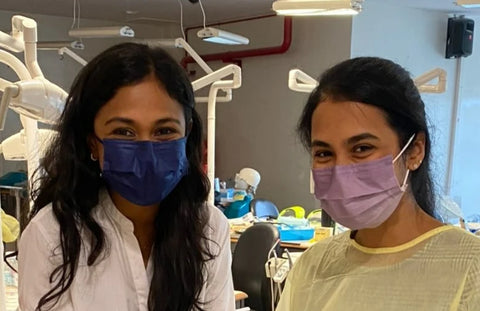 Two female dental student on the right and dentist lecturer on the left smiling behind the face mask because they are happy with Mr Bur Dental burs that they were using at the workshop
