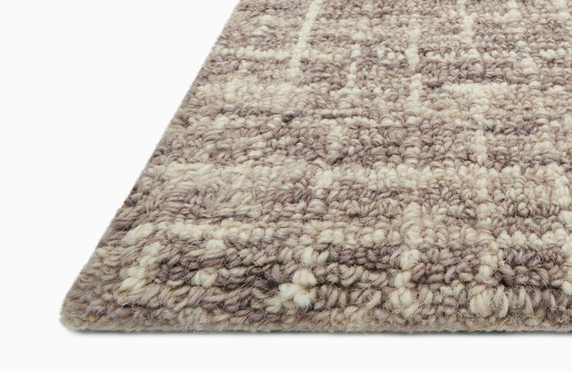 Close-up of a thick, textured wool rug in a neutral checker pattern, highlighting its loop-pile weave and plush construction.
