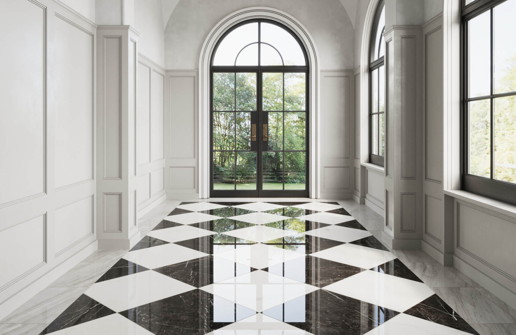 Elegant hallway featuring large black and white marble checkered tiles, with arched windows and doors framing a scenic outdoor garden view.
