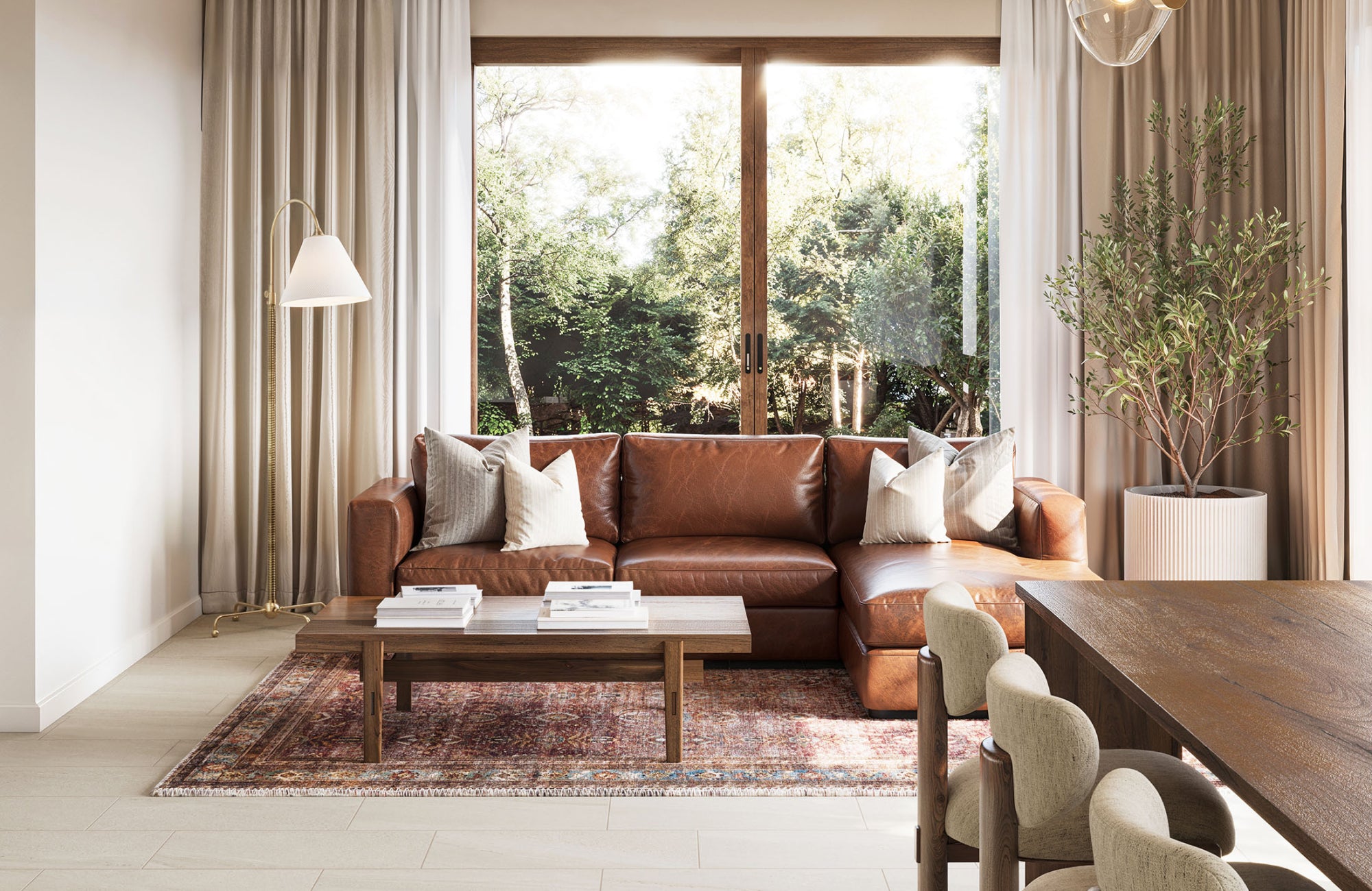 Warm living room with a brown leather sofa, rustic wood furniture, and a vintage-style rug, complemented by natural light and greenery.
