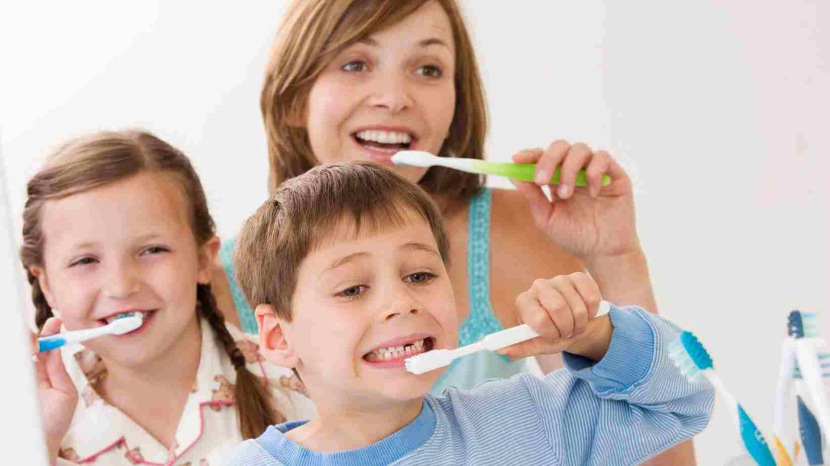 A family brushing her teeth