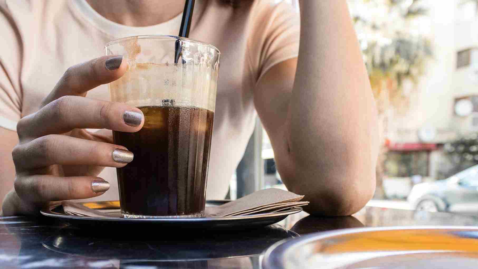 A woman drinking coffee with straw