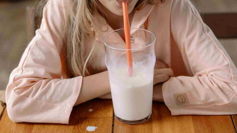 A woman having coffee with milk