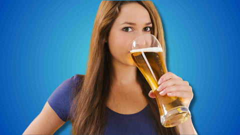 A woman drinking beer