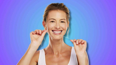 A woman flossing teeth