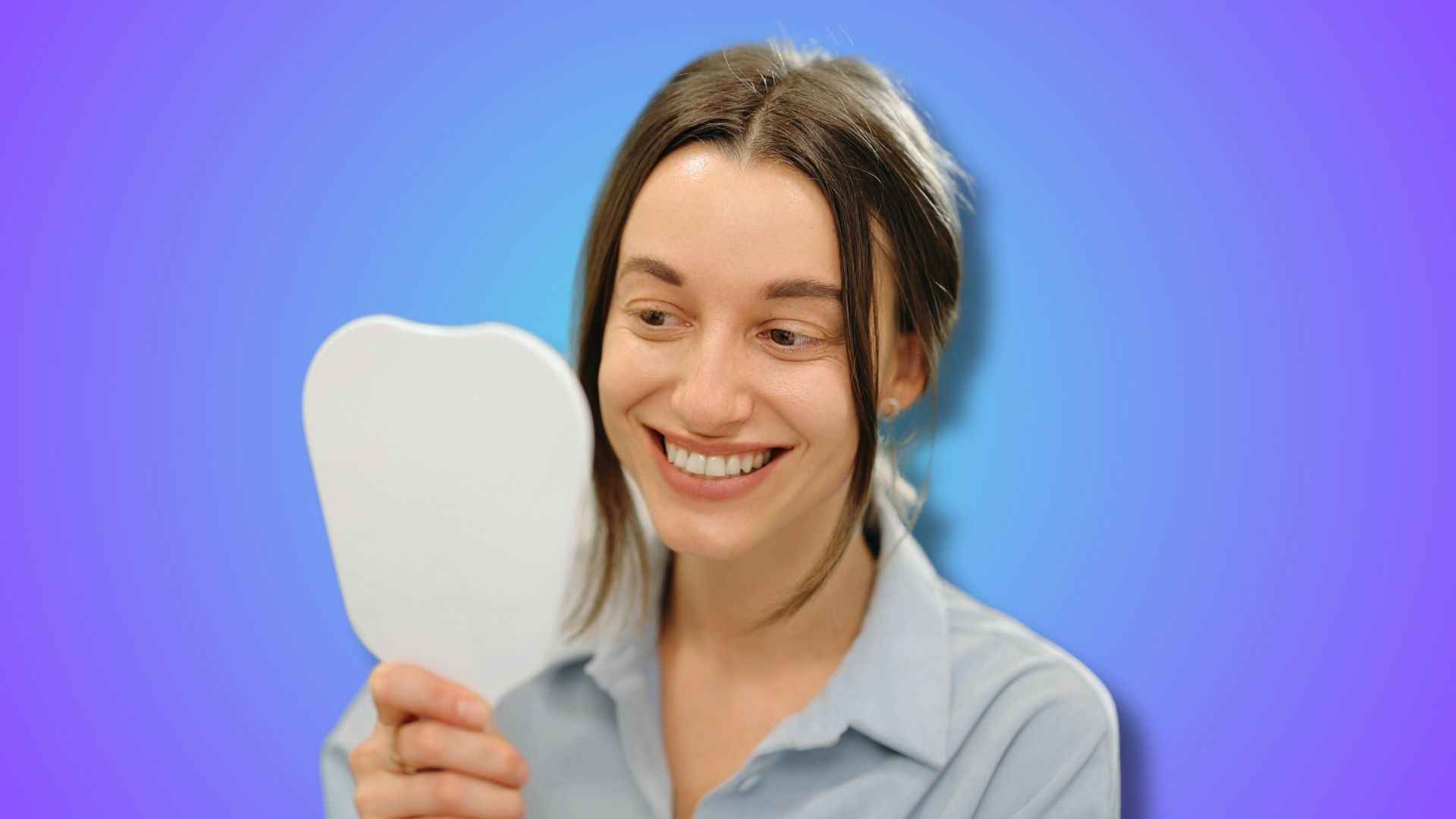 A woman checking her teeth in front of the mirror