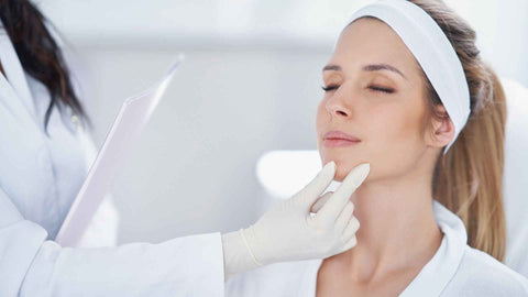 The dermathologist checking her patient face
