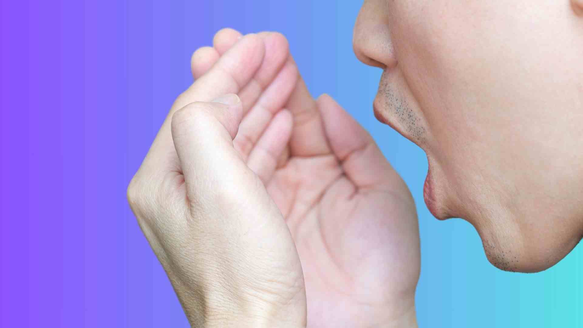 A person checking his breath