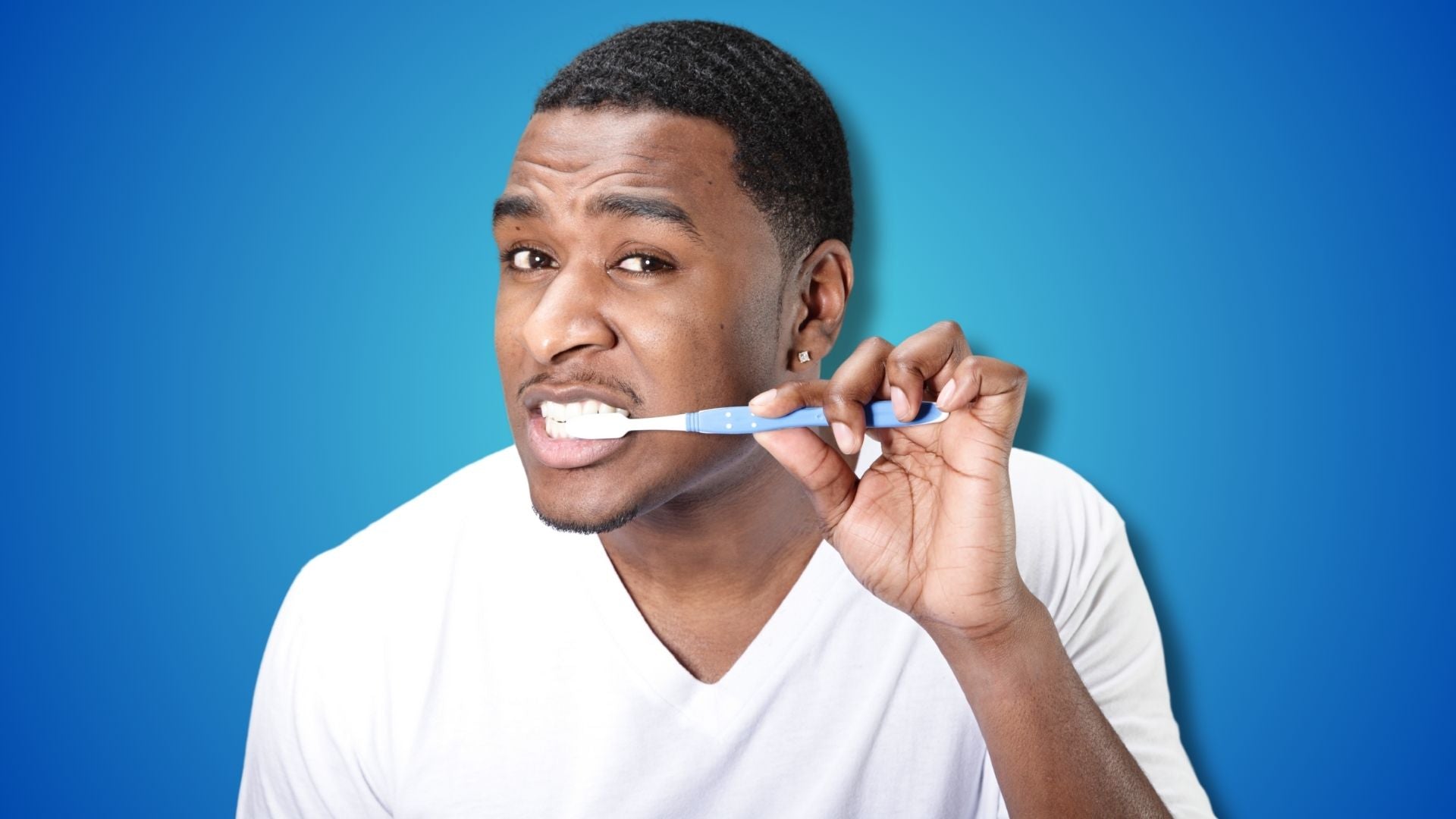 A man brushing her teeth