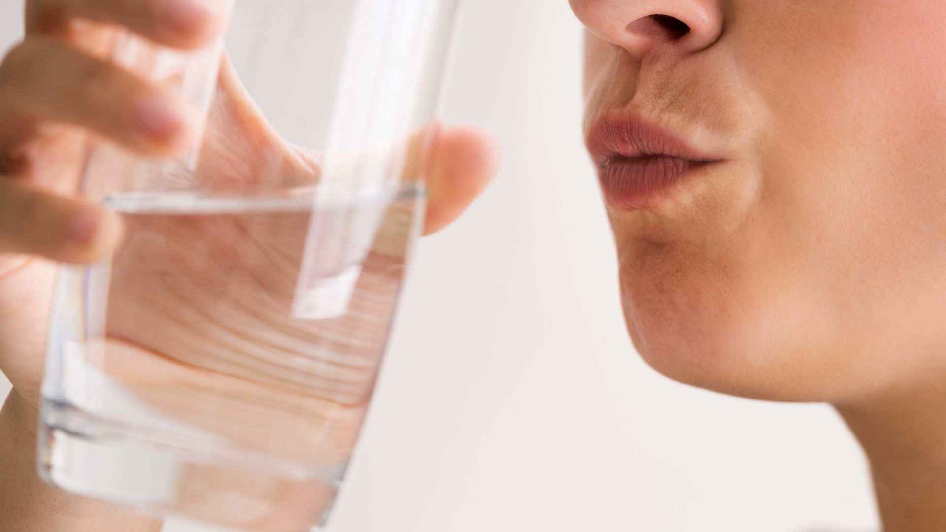 A woman rinsing her teeth