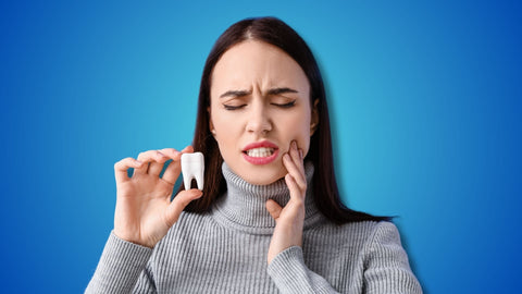 A woman holding tooth model