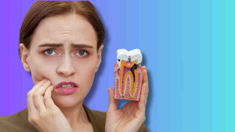 A woman holding a tooth cavities model