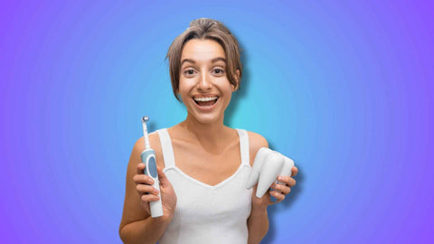 A woman holding toothbrush and tooth model