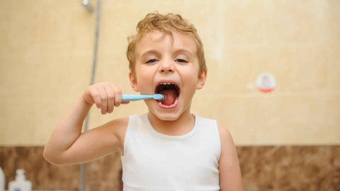 a kid brushing his teeth