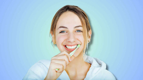 A person brushing her teeth